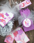 Various handmade gift boxes with Valentine's themed items on tags.