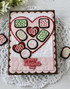 Handmade greeting card with heart on it and chocolates with happy valentine's day sentiment on it.