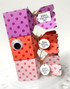Handmade greeting boxes with tags on each of them that say happy valentine's day.