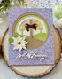 Handmade greeting card with cross in center of a meadow on it.