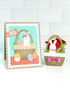 Handmade greeting card with a bunny on it and a basket with a bunny in it next to it.