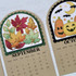 Two handmade calendars with leaves and pumpkins on each.