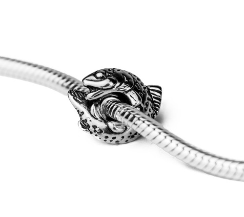 This handmade sterling silver fish charm is from the locally made Teton Jewelry Collection.