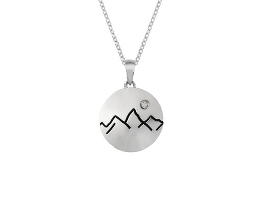 This handmade sterling silver large Grand Teton Mountain Range line outline circle disk pendant with the chain featuring a Crystal is from the locally made Teton Jewelry Collection.