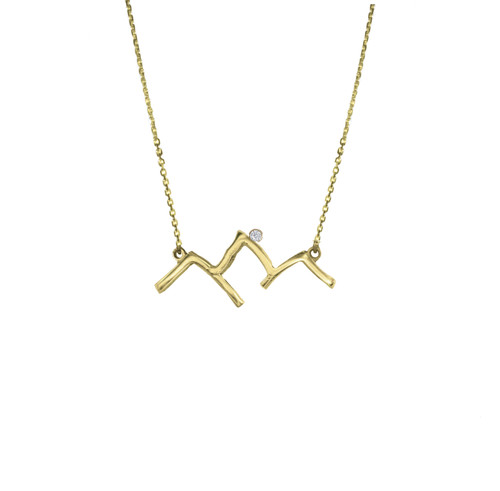 This handmade Grand Teton Mountain Range outline necklace in 14k yellow gold featuring a .02k diamond and an adjustable 1.3mm rolo chain is from the locally made Teton Jewelry Collection.