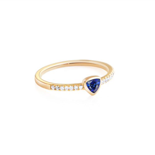 This 14k yellow gold ring featuring stamped diamonds along the band and a 4mm trilion Blue Sapphire stone is from the Fine Jewelry Mewar Collection.