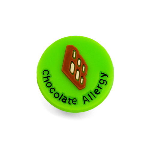 Bright green round charm with graphic of chocolate bar and says Chocolate Allergy