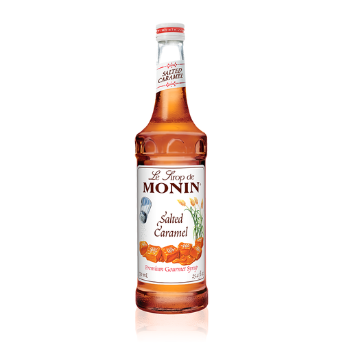 A 750 mL (25.4 fl oz) bottle of Monin Salted Caramel Premium Gourmet Syrup. The amber syrup is visible through the bottle, which features a white label with the Monin logo and illustrations of a salt shaker, stalks of grain, and cubes of caramel topped with sea salt. The label includes the text "Salted Caramel" and "Premium Gourmet Syrup."
