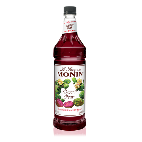 A 1-liter (33.8 fl oz) bottle of Monin Desert Pear Premium Gourmet Syrup. The deep magenta-colored syrup is visible through the bottle, which features a white label with the Monin logo and botanical illustrations of prickly pear cactus pads, yellow blossoms, and sliced prickly pear fruit. The label includes the text "Desert Pear" and "Premium Gourmet Syrup."