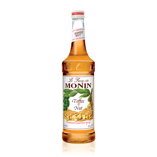 A 750 mL (25.4 fl oz) bottle of Monin Toffee Nut Premium Gourmet Syrup. The amber syrup is visible through the bottle, which features a white label with the Monin logo and illustrations of toffee pieces, hazelnuts, and green leafy branches. The label includes the text "Toffee Nut" and "Premium Gourmet Syrup."
