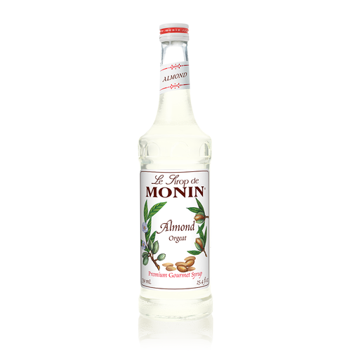 A 750 mL (25.4 fl oz) bottle of Monin Almond (Orgeat) Premium Gourmet Syrup. The cloudy, translucent syrup is visible through the bottle, which features a white label with the Monin logo and botanical illustrations of green almond husks on the branch, small blossoms, and shelled almond nuts. The label includes the text "Almond Orgeat" and "Premium Gourmet Syrup."