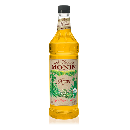 A 1-liter (33.8 fl oz) plastic bottle of Monin Agave Organic Nectar. The clear bottle contains a bright golden syrup and features a parchment-style label with the Monin logo. The label includes detailed illustrations of blue agave plants and harvested agave hearts (piñas), a "USDA Organic" seal, and the text "Agave Organic Nectar."