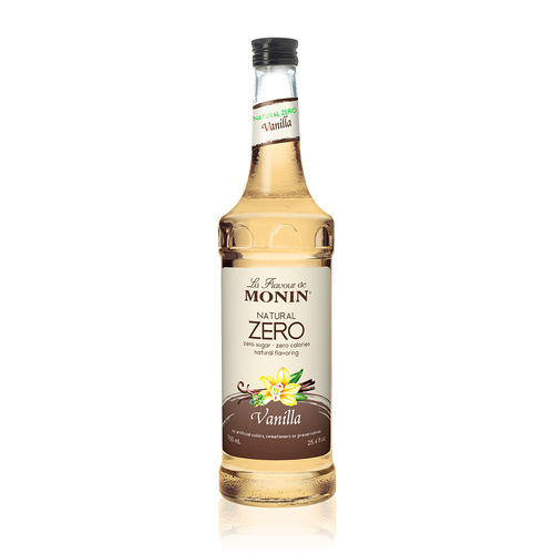 A 750 mL (25.4 fl oz) glass bottle of Monin Natural Zero Vanilla syrup. The label features a cream-colored background with an illustration of a vanilla flower and pods. It prominently displays "Natural Zero" and "Vanilla," noting it has zero sugar, zero calories, and no artificial sweeteners, colors, or preservatives. The syrup inside is a pale golden color.