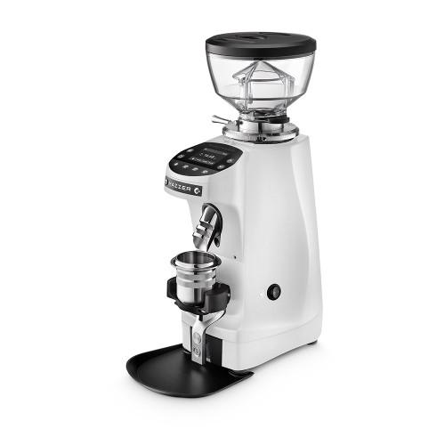 A front perspective of a white Mazzer espresso grinder. The unit includes a clear bean hopper, a digital touch-control display for programmable dosing, and a silver coffee grounds chute. This model is shown with a silver dosing cup held in a black portafilter fork above a black grounds tray.