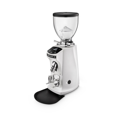 A front perspective of a white Mazzer espresso grinder. The unit features a clear bean hopper with a black lid, a digital touch-control display for programmable dosing, and a silver coffee grounds chute. It includes an adjustable portafilter fork and sits on a black grounds tray against a white background.