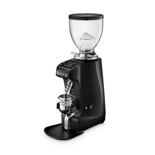 A front perspective of a black Mazzer espresso grinder. The unit includes a large clear bean hopper with a black lid, a digital touch-control display for programmable dosing, and a silver coffee grounds chute. This model is shown with a silver dosing cup resting in a black portafilter fork above a black grounds tray at the base.