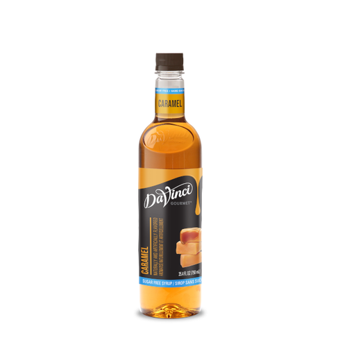 A 25.4 FL OZ (750 mL) glass bottle of DaVinci Gourmet Sugar Free Caramel Syrup. The clear bottle contains amber-colored syrup with a dark cap and a light blue neck band reading "Caramel". Its black main label features white script branding above vertical text reading "Caramel," a light blue bottom strip reading "Sugar Free Syrup / Sirop Sans Sucre," and an illustration of stacked caramel chews with soft caramel filling inside.