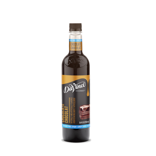 A 25.4 FL OZ (750 mL) glass bottle of DaVinci Gourmet Sugar Free Chocolate Syrup. The bottle contains dark brown syrup with a dark cap and a light blue neck band reading "Chocolate / Chocolat". Its black main label features white script branding above vertical text reading "Chocolate / Chocolat," a light blue bottom strip reading "Sugar Free Syrup / Sirop Sans Sucre," and an illustration of stacked dark chocolate squares topped with chocolate syrup drizzle.