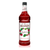 A 1-liter (33.8 fl oz) bottle of Monin Raspberry Premium Gourmet Syrup. The deep red syrup is visible through the bottle, which features a white label with the Monin logo and botanical illustrations of ripe raspberries and green leaves. The label includes the text "Raspberry" and "Premium Gourmet Syrup."
