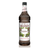 A 1-liter (33.8 fl oz) plastic bottle of Monin Huckleberry Premium Gourmet Syrup. The clear bottle contains a dark, deep purple syrup and features a white label with the Monin logo. The label is decorated with illustrations of huckleberry branches, featuring green leaves and small dark berries, surrounding the text "Huckleberry" and "Premium Gourmet Syrup." A matching "Huckleberry" label is also visible around the neck of the bottle.