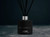 Mystique - Coco by Chanel perfume inspired reed diffuser on slate floor Mystique - Coco by Chanel perfume inspired reed diffuser on slate floor