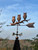 Three owls on a branch weathervane