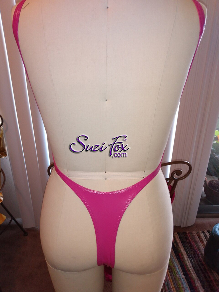 Womens One Piece T-back Thong Swim Suit shown in Fuchsia Vinyl/PVC Spandex, custom made by Suzi Fox.
• Custom made to your measurements.
• The high leg hole, low back and t-back thong rear create a stunning and sexy suit.
• Available in any fabric on this site.
• Made in the U.S.A.