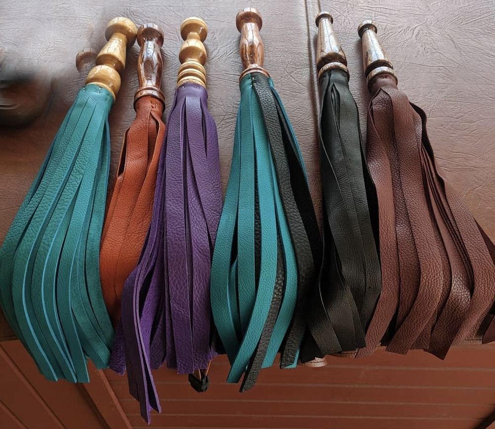 Leather Floggers with walnut handle or finger handle. Colors may vary.