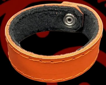 Orange 100% Leather wrist band.
They are fleece lined to be super comfortable and can be worn anywhere.