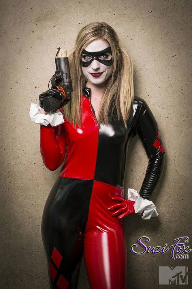 Customer Picture! She did Cosplay at Comic Con 2015 - photo by MTV!
Custom Harley Quinn Catsuit by Suzi Fox in Stretch Gloss Red and Black Vinyl coated Nylon Spandex.
Includes catsuit, gloves, wrist ruffles. Mask not included.
Popular fabrics are: red & black vinyl/PVC, red & black metallic foil, red & black wet look lycra Spandex.
• Optional 1 or 2-slider crotch zipper.
• Optional wrist zippers
• Optional ankle zippers
• Made in the U.S.A.