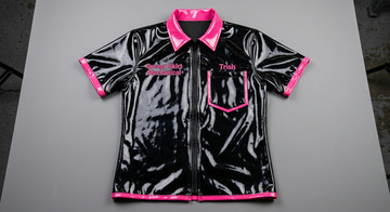 Gloss black vinyl short sleeve jacket with pointed collar, breast pocket, short sleeves, binding on sleeves and hem and pocket. Binding and collar are neon pink vinyl. Black molded plastic zipper. Binding fee later.