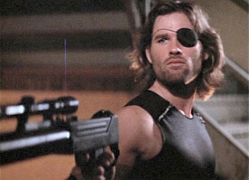 Escape From New York (1981) is a cult-classic action film featuring the dream team of John Carpenter and Kurt Russell. The story is one of the classics: a rescue mission. The President's plane has crashed in the badlands, and so Police Commissioner Bob Hauk (Lee Van Cleef) is forced to recruit the most Badass criminal available to go in after him. That man is Snake Plissken.