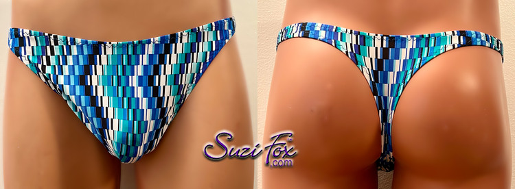 Mens Smooth Front, Wide Strap, T-back Thong- shown in random blue squares on spandex, custom made by Suzi Fox.
THIS SUIT IS ONE OF A KIND! IN STOCK, READY TO SHIP!
• Size Medium Waist 32-35 inches (81.28-88.9 cm)
• Front height is 7 inches (17.78 cm).
• Made in the U.S.A