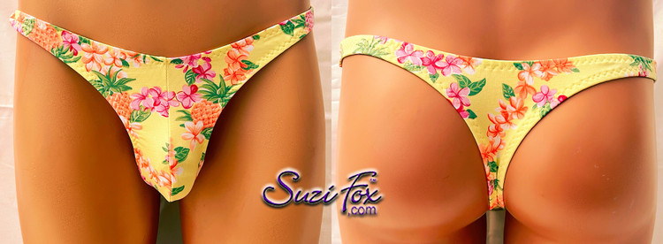 Mens Pouch Front, Wide Strap, T-Back thong - shown in LIMITED EDITION Pineapple and flowers on yellow spandex, custom made by Suzi Fox.
THIS IS ONE OF A KIND! Brand new! Ready to ship!
• Size Medium, Waist 32-35 inches (81.28 cm - 88.9 cm)
• Standard front height is 6 inches (15.24 cm).
• Standard pouch size is 2 inches (5.08 cm).
• Made in the U.S.A.
