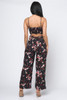 WB10-56606-TB-1282 BLACK FLOWERS PRINT ROUND NECK SPAGHETTI STRAP JUMPSUIT WITH CUT OUT IN THE BACK  (1,2,2,2 - S,M,L,XL)