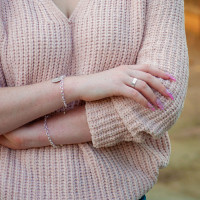 Custom Hand stamped sterling silver wide band ring, shown on a model with other rings