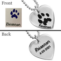 Custom necklace personalized with pet's actual paw print, engraved on a sterling silver heart charm, shown with original pawprint. Owner's handwriting shown engraved on front, and the name & date shown on back