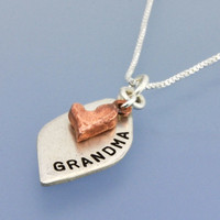 Close up of Hand Stamped Loved Petal Necklace, in fine silver and copper, shown from the side