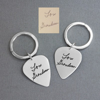 Custom memorial silver guitar pick key rings with handwriting, shown with the original signature from Grandma  used to personalize them