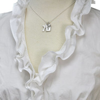 Silver charm with raised edge & the handwritten word Love, with a fine silver cross and fine silver heart, shown on a neckform