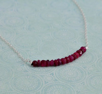 Mother's necklace with July birthstones, shown from side