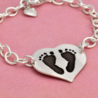 Side view of custom silver heart bracelet personalized with your child's actual footprints or handprints