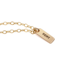 Side view of custom personalized necklace with gold rectangle charm for mom, stamped with son's name