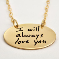 Custom gold oval necklace with your actual handwriting, shown from the side on white