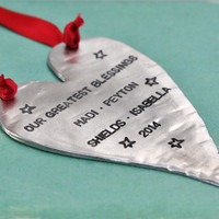 Custom fine pewter Christmas ornament, personalized with your message, shown from the side on green