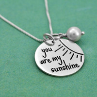 Sterling silver You Are My Sunshine necklace with birthstone, shown from the side