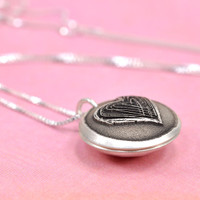 Silver Heart locket for mom with hand stamped message inside, shown from side