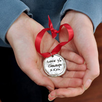 Custom fine pewter Christmas ornament, personalized with your handwriting, shown in model's hands