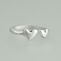 Hand crafted silver ring with two hearts, side view