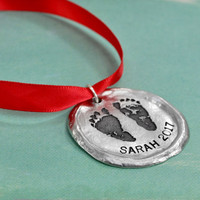 Custom fine pewter memorial Christmas ornament, personalized with your child's footprints or handprints, shown on green